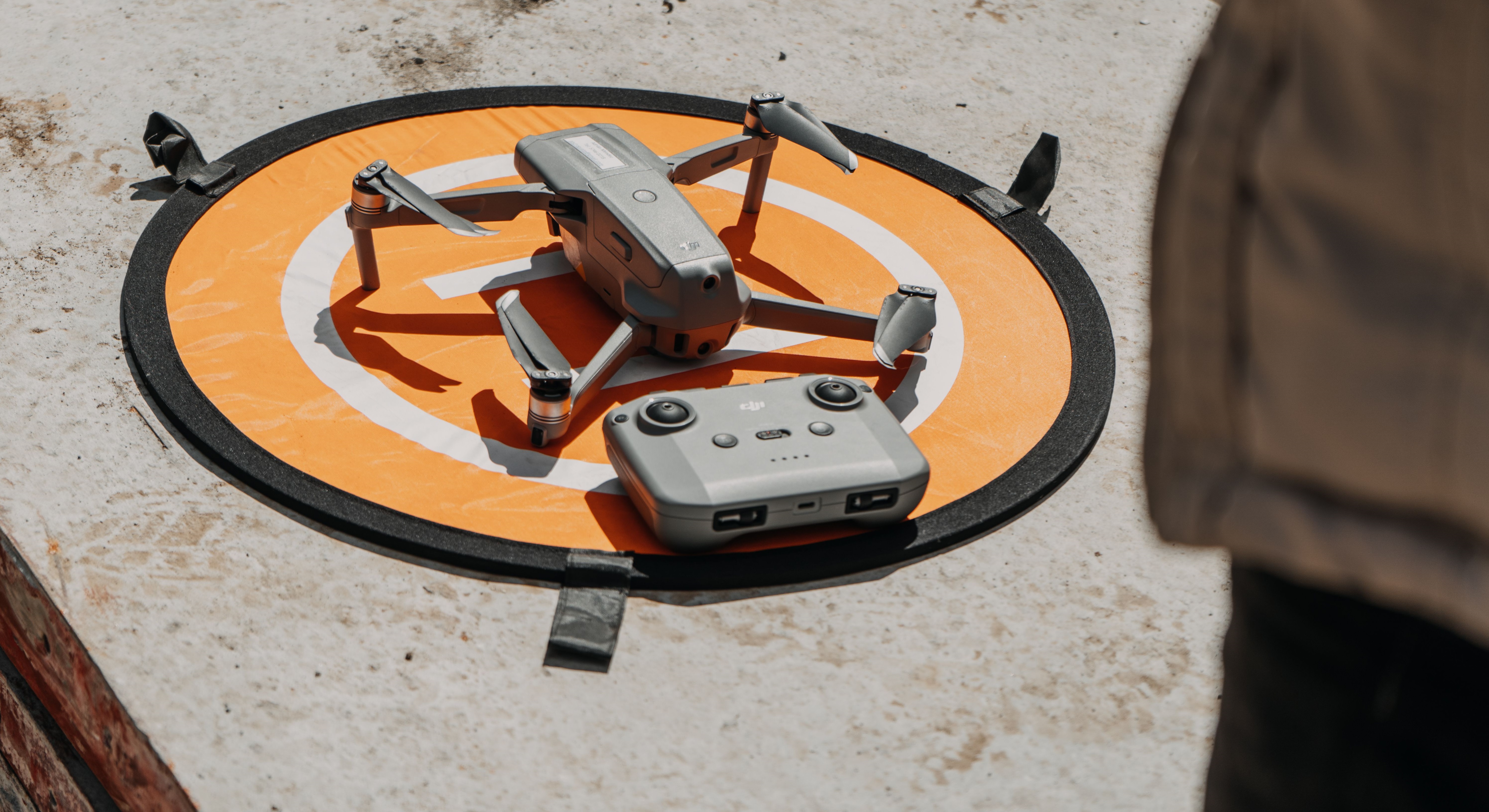 Certified drone operator controlling a drone in flight outdoors